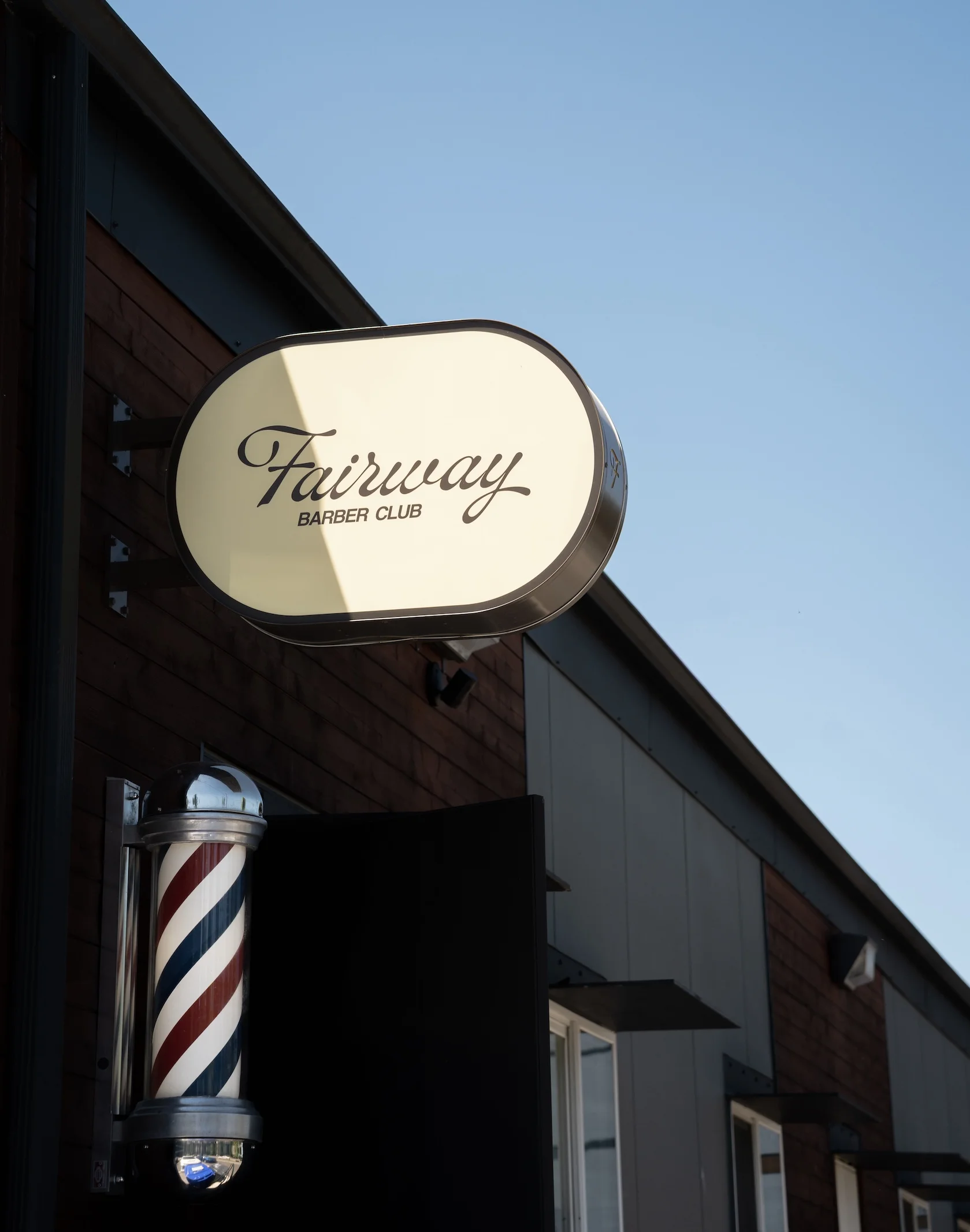 Fairway Barber Club blade sign and barber pole outside the shop